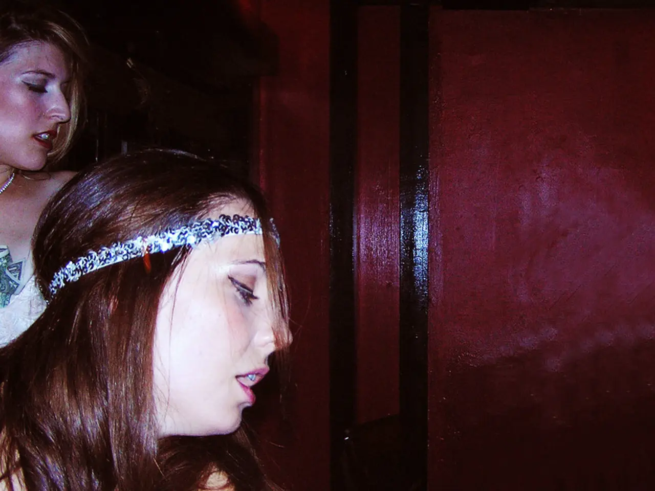 In this picture we can see there are two women on the path and on the right side of the women there...