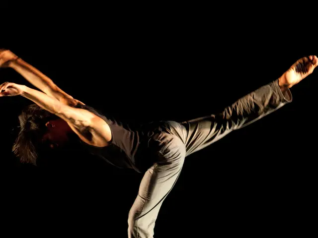 In this image there is a person standing on the chair with one leg.