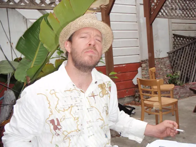 in this picture there is a man who is sitting at the left side of the image and he is smoking,...